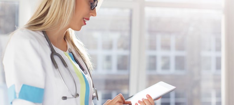 female doctor using a computing tablet