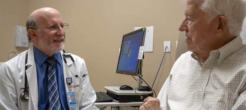 Dr. Greg Sachs consulting with a patient