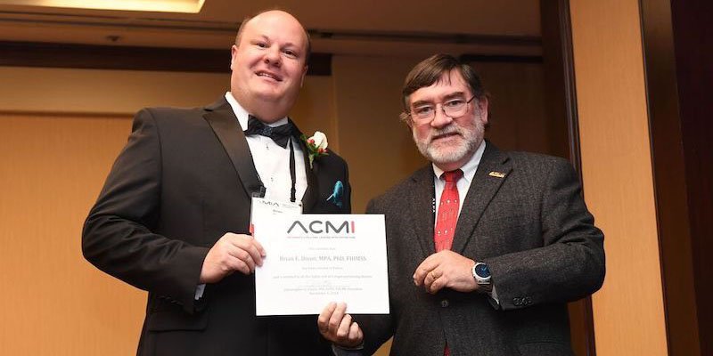 Brian Dixon accepts FACMI award