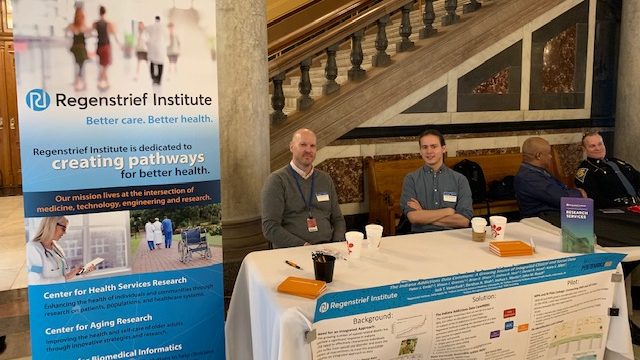 Regenstrief employees sit at table at Indiana Statehouse