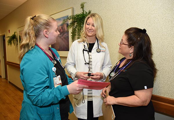 Probari nurses and doctor consult in an extended-care facility