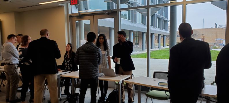 Attendees network to discuss implementing AI