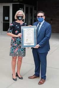 Dr. Box and Dr. Embi holding the public health award for excellence