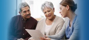 A healthcare provider discussing care with a couple. Language can be a barrier to healthcare for minorities.