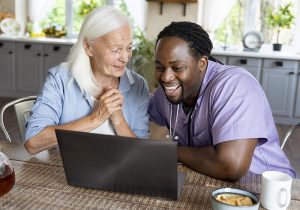 elderly woman working with an in-home social/medical worker