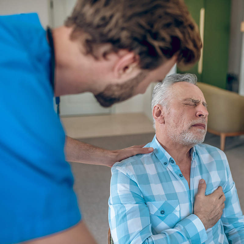 Cardiologist providing first aid to a patient with a heart attack