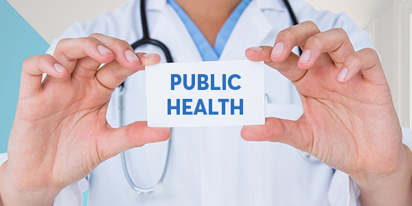 doctor holding up a card that says "public health"