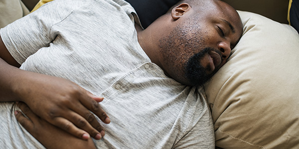 African American man sleeping in bed